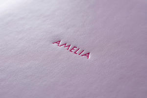 Embossed text finished in pink foil on pink leatherette